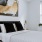 a bedroom with a painting on the wall