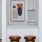a room with stools and a painting on the wall