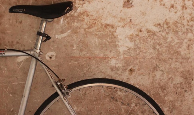 a bicycle parked against a wall
